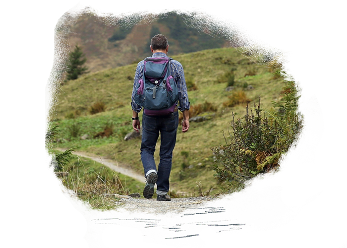 Image of tourist walking on track from behind